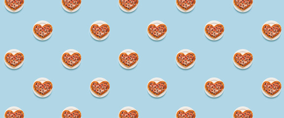 Many heart-shaped pizzas on light blue background. Pattern for design