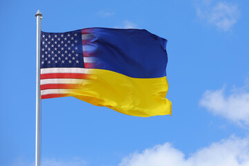 Waving flag in national colors of Ukraine and USA outdoors