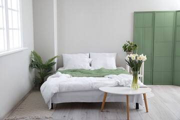 Interior of modern bedroom with green folding screen