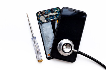 Fototapeta na wymiar Electronics servise and repair concept - mobile phone with circuit board