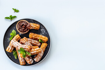 Churros fried pastry with chocolate sauce. Street food dessert