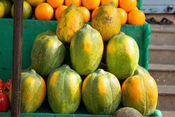 PUNE, INDIA - SEPTEMBER 25, 2015: Close-up of papayas stacked on top of each other.