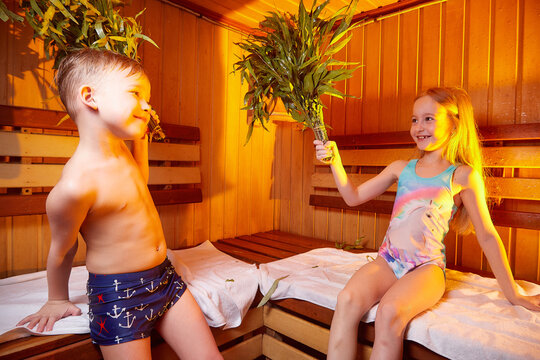 A girl and a boy in a Russian bath. Bathhouse in Russia for a family with a brother and sister. The concept of a healthy baby in the steam room
