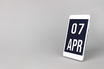 April 7th. Day 7 of month, Calendar date. Smartphone with calendar day, calendar display on your smartphone.  Spring month, day of the year concept.