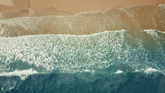 B roll - Summer topical sand beach and sea wave. Aerial view of drone. Top view of surf on sand. Beautiful of sunset white sand beach. Perfect for holiday summer background. Slow motion.
