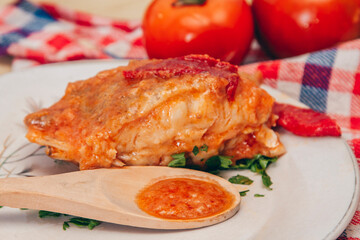 slice of grilled fish with tomato sauce and red peppers