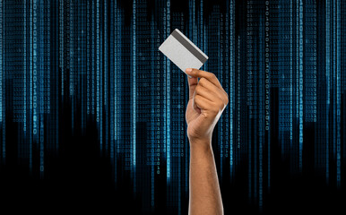 shopping, finance and people concept - close up of female hand with silver credit card over binary code on black background