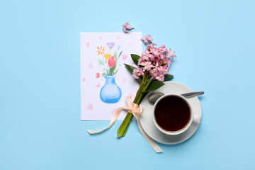 Obraz na płótnie Canvas Picture with flowers and cup of coffee on blue background. Mother's Day celebration