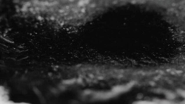 Grunge background. Ice frost. Logo revealing frame. Crystal texture. Defocused black white ink dirt stain spreading motion on dark night abstract overlay.