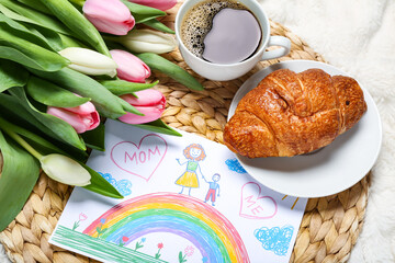 Picture with tulips, cup of coffee and croissant on white blanket. Mother's Day celebration
