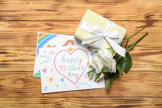 Pictures with text HAPPY MOTHER'S DAY, flowers and gift box on wooden background