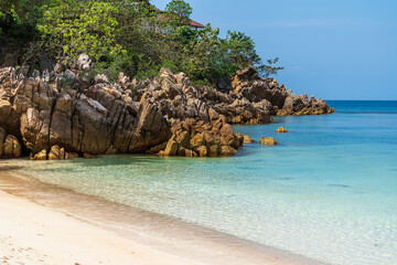 Beautiful tropical sand beach with rock and blue sea water at morning on Koh Phangan island, Thailand