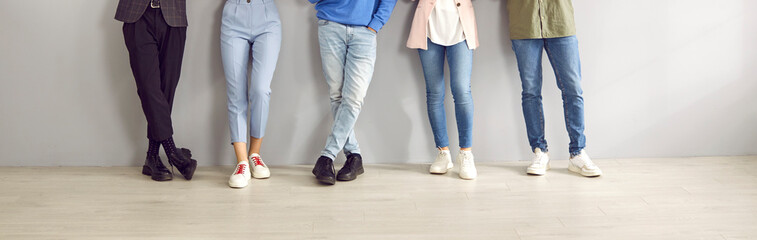 Banner shot of legs of young unrecognizable stylish people in smart and casual clothes. Cropped...