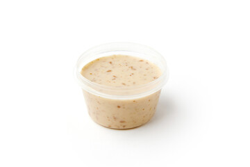 Natural sesame sauce in plastic jar isolated on white