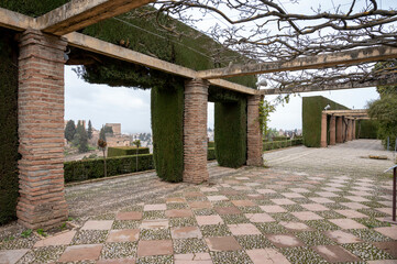 Obraz premium Gardens and buidings of medieval palace Generalife in fortress Alhambra, Granada, Andalusia, Spain