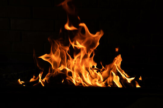The texture of the fire is close, red and yellow, thermal energy at the fuel supply point at night, lights on a black background.