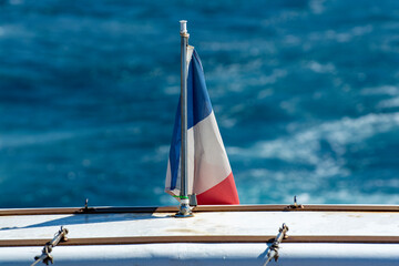 Fototapeta na wymiar French flag, boat excursion to Calanques national park in Provence, France