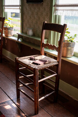 Old fashioned wooden chair in sunlights, Dutch interior and room decoration in rich fisherman's house in North-Holland, Enkhuizen, Netherlands