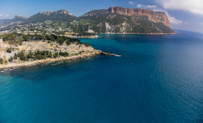 Fototapeta na wymiar Panoramic aerial view on cliffs, blue sea, beach, houses, streets and old fisherman's harbour with lighthouse in Cassis, Provence, France