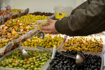 Assortment of pickled green olives for sale on farmers market in Malaga, Andalusia, Spain