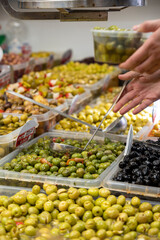 Assortment of pickled green olives for sale on farmers market in Malaga, Andalusia, Spain