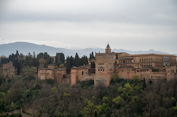 Fototapeta na wymiar View on medieval fortress Alhambra and snow on Sierra Nevada mountains, Granada, Andalusia, Spain