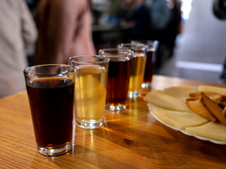 Tasting of different sweet wines from wooden barrels on old bodega in central part of Malaga, Andalusia, Spain