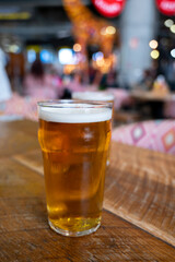 Fresh draught lager beer is glass served in indoor cafe