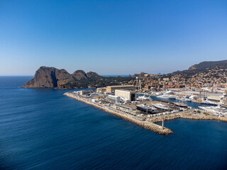 Panoramic aerial view on historical coastal Provencal city La Ciotat with large sailboat harbour and yacht shipyard, summer vacation in Provence, France