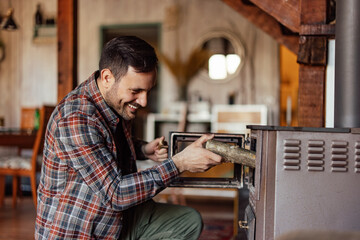 Smiling man enjoying in wooden cottage.