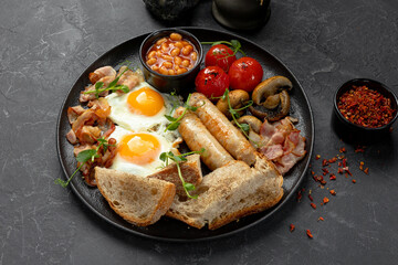 Traditional English breakfast with eggs sausages and beans