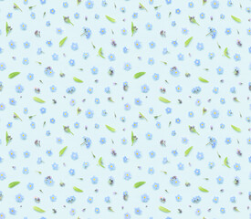 Seamless floral pattern of spring forget-me-not flowers buds and leaves on blue background top view flat lay