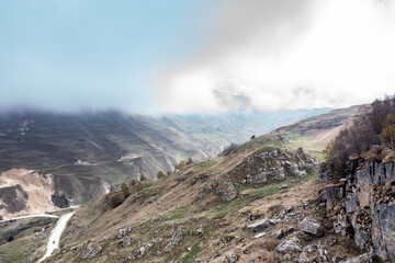 panoramic view of the Caucasus Mountains gorges ancient fortresses and curved mountain roads on a spring day taken from a drone