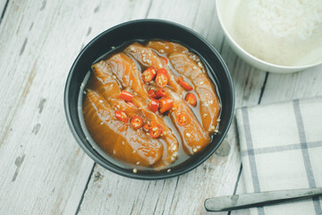 Raw salmon in soy sauce marinated sprinkle red chili and white sesame. Good tasty dish.