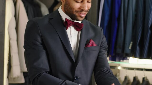 Luxury suit shop in front of the camera Afro American guy try a new suit from a new collection he is feeling very great and comfortable