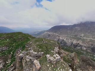 panoramic view of the Caucasus Mountains gorges ancient fortresses and curved mountain roads on a spring day taken from a drone