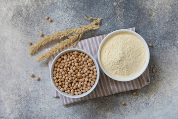 Food and baking gluten-free protein ingredient. Chickpea flour wholesome and raw chickpea over gray...