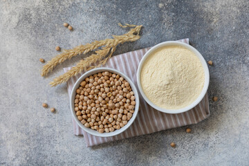 Food and baking gluten-free protein ingredient. Chickpea flour wholesome and raw chickpea over gray stone table. Top view flat lay.