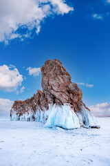 Beautiful landscape island Ogoy winter lake Baikal with transparent cracked blue ice sunset. Concept travel Russia