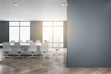 Modern meeting room interior with mock up place on wall, wooden flooring, furniture, city view and daylight. 3D Rendering.