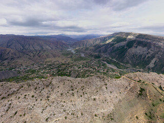panoramic view of the Caucasus mountains gorges ancient fortresses and curved mountain roads on a spring day