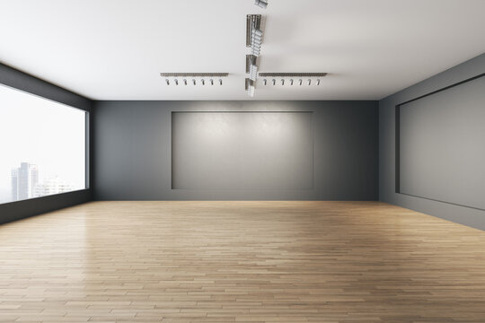 Contemporary empty concrete gallery interior with window and city view, wooden flooring, mock up place on walls and daylight. Museum concept. 3D Rendering.