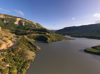 panoramic view of the Caucasus Mountains gorges and curved mountain roads on a spring day
