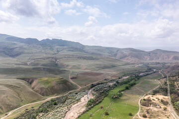 Fototapeta premium panoramic view of the Caucasus Mountains gorges and curved mountain roads on a spring day
