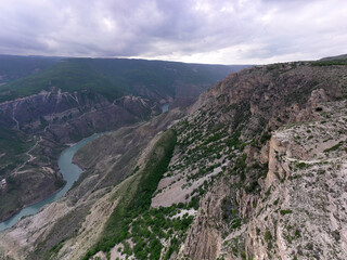 Fototapeta na wymiar panoramic view of the Caucasus Mountains gorges and curved mountain roads on a spring day