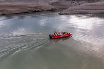 mountain lake with a beautiful and ethereal coastline with a red boat