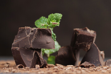 Broken dark chocolate and cocoa powder on a table
