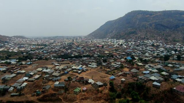 Kubwa Village is a suburban area of Abuja Nigeria with many homes built in the valley of the mountain - aerial view