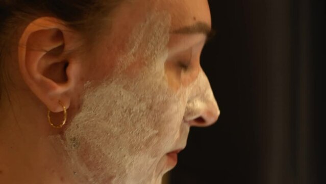 Young woman takes care of their problematic facial skin by applying the cream.