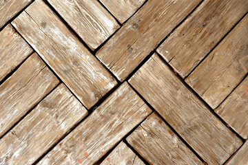 Natural textured background of old vertical wooden planks stacked diagonally.